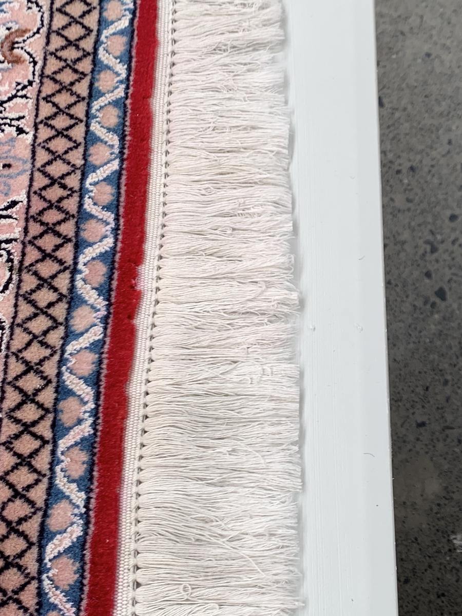The same fringe after RugMaster drew the migrated dye out, back to its original white