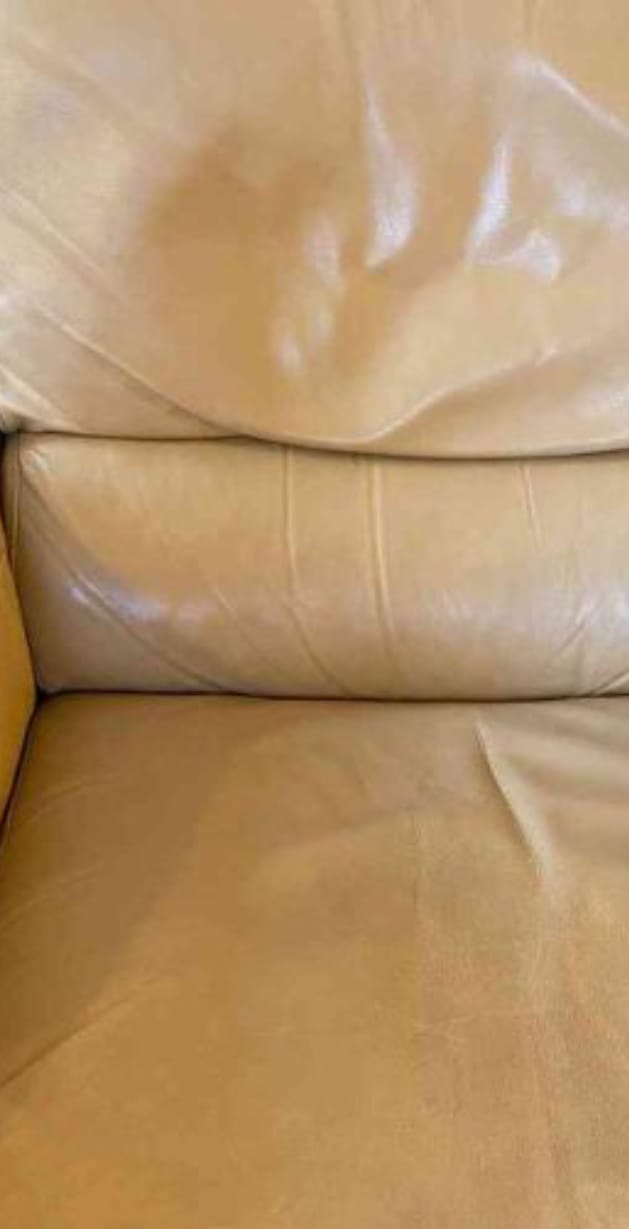 A cream leather lounge suite before cleaning