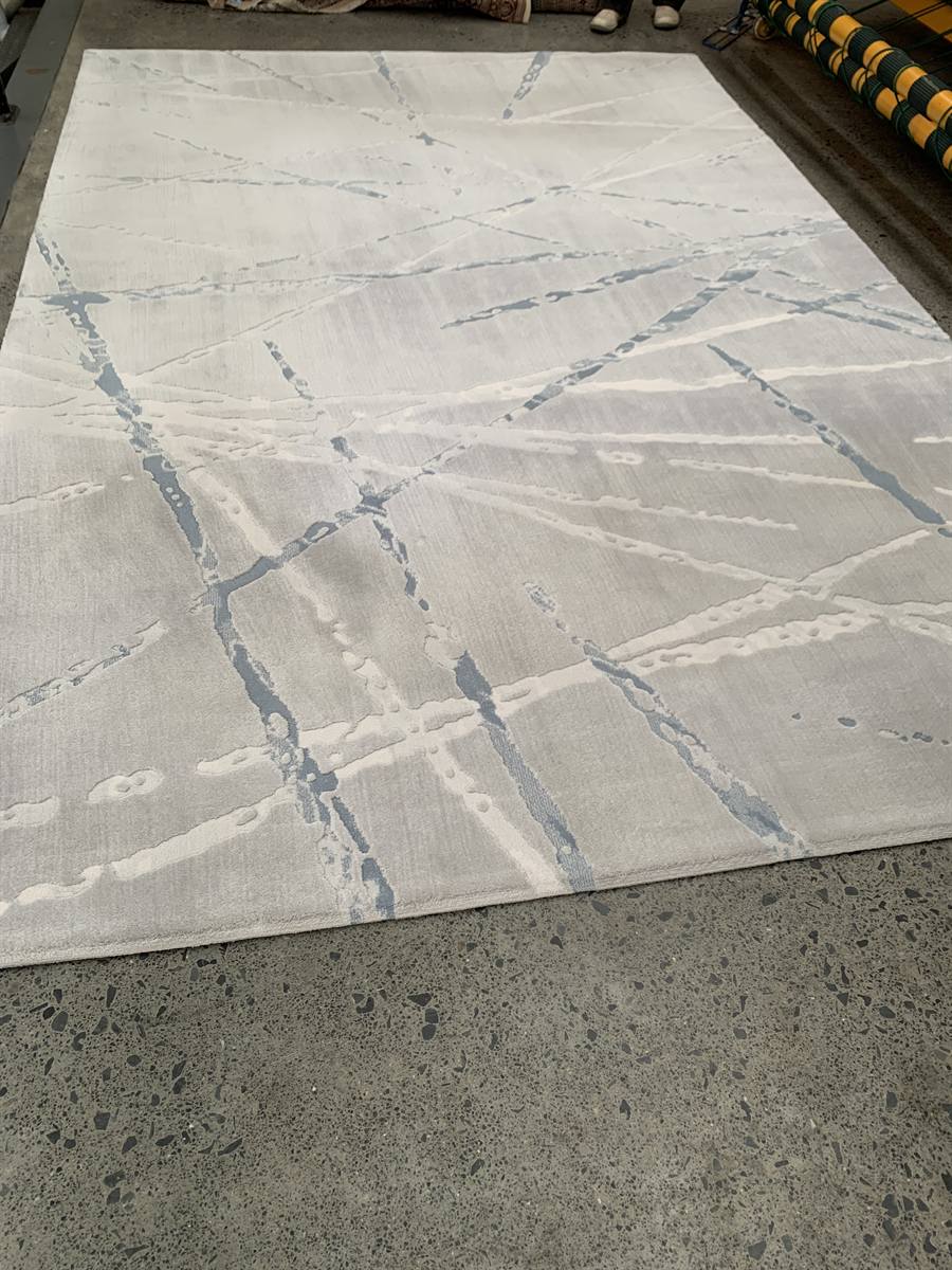 The same rug after washing at the RugMaster plant, the ground back to pale silver and the blue detail visible again