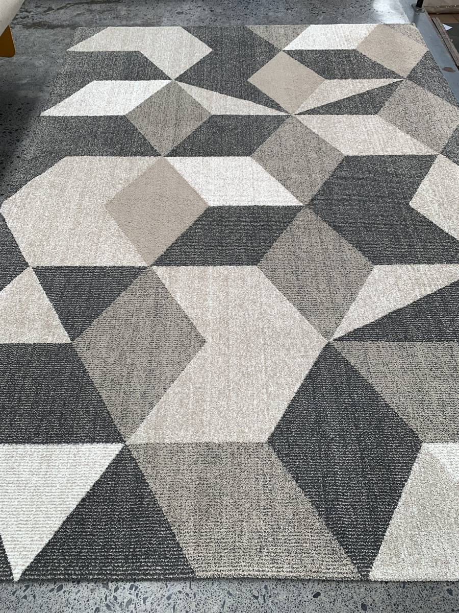 The same geometric rug after washing, the light and dark blocks sharply separated again