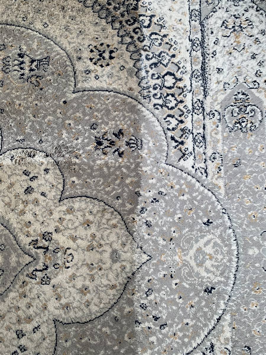 Close detail of the washed rug, showing the fine pattern work in the medallion
