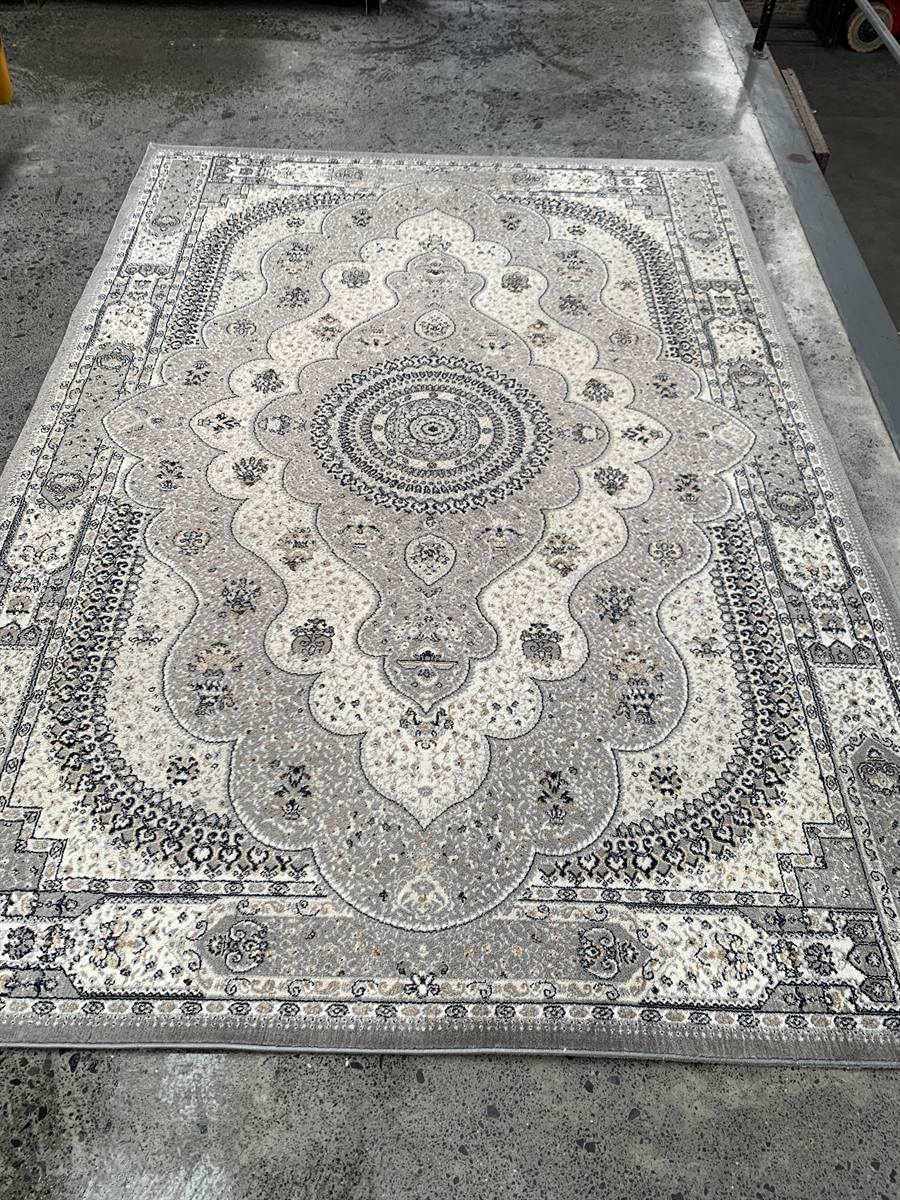 The same medallion rug washed, dried flat and laid out, its centre medallion and borders crisp again